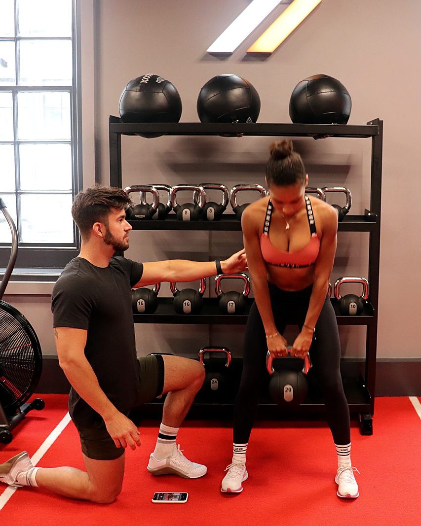 Olly Banks coaching a client through a kettlebell deadlift